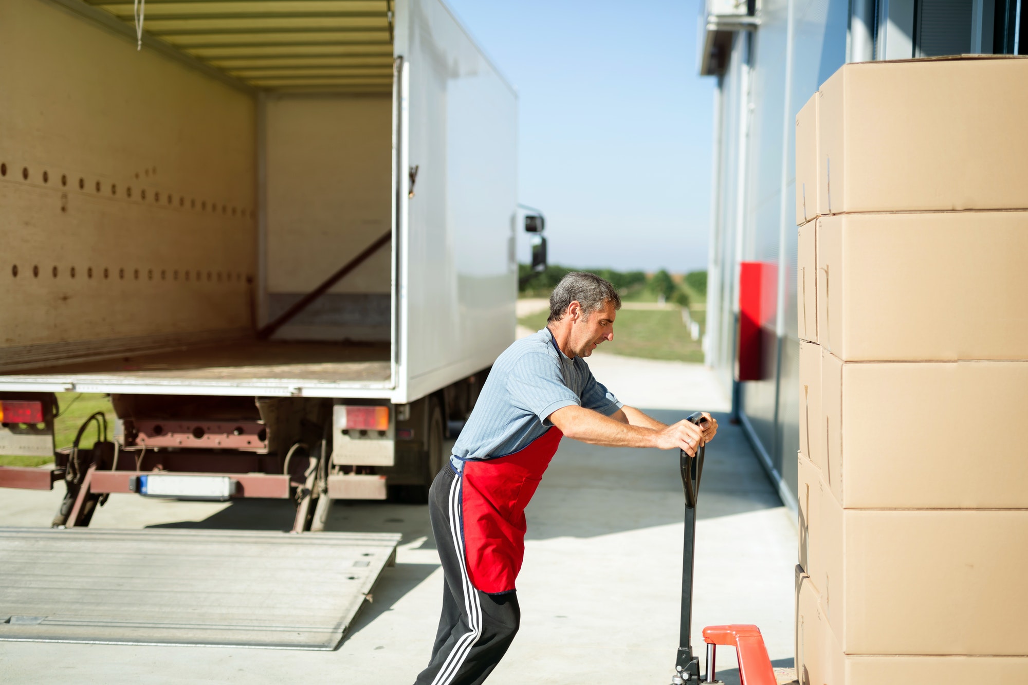 Logistics worker carrying delivered goods